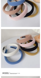 Detail of waffle-textured headbands in multiple colors featuring a black handmade label