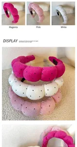 Detailed view of padded polka dot headbands in rose red, pink, and white color options