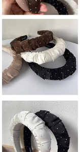 Close-up of pleated satin headband with sparkling rhinestones and hand made label
