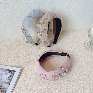 Knotted wide pearl headband for women featuring gold beads in pink, beige and blue colors