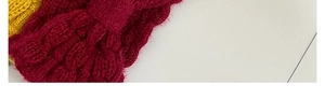 Detail of cable knit texture on burgundy and mustard yellow winter bow headbands