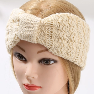 Beige knitted twist headband with chunky texture for women on a white background