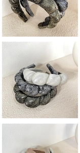 Detail shot of three thick metallic bubble headbands in pearl white, silver, and bronze black