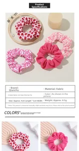 Close-up of pink fabric scrunchie set with heart and floral patterns for hair styling
