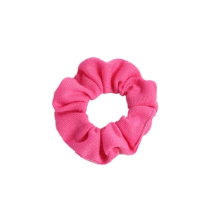 Pink knitted heart-style scrunchie hair tie with ribbed texture on white background