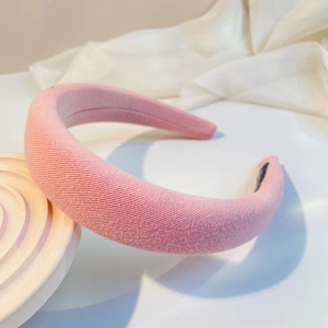 Detail of pink padded headband showing textured knit fabric and premium thick sponge core
