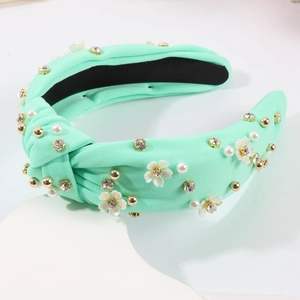 Détails du serre-tête noué vert menthe orné de perles, de fleurs et de strass brillants