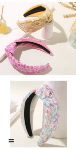 Nahaufnahme glitzernder Pailletten-Haarreifen mit Knoten in Gelb, Rosa und Bunt