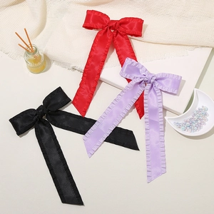 Elegant satin bow hair clip set in red, purple and black with pleated edges and long ribbons
