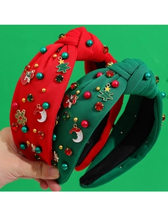 Close-up of festive Christmas knotted headband with beads and enamel charms