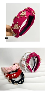 Detail of knotted fabric headband with pearls and colorful heart-shaped rhinestones