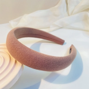 Detailed view of the thick padded pink sponge headband with knitted texture fabric