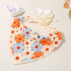 Detail of hand-crocheted floral headscarf in orange and blue with woven straps