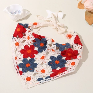 Detail of floral crochet cotton headband with white ties and intricate knitted flower patterns