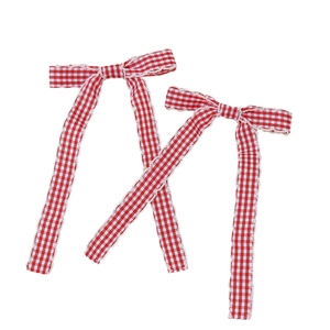 Pair of red plaid bow hair clips with white lace trim and long flowing ribbons
