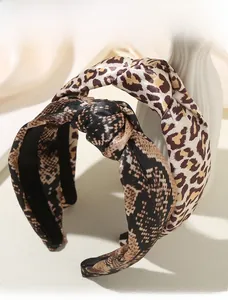 Close-up of leopard and snake print twisted headbands with a satin finish texture