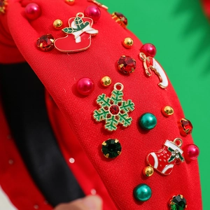 Red Christmas fabric twist headband decorated with festive charms and colorful pearls