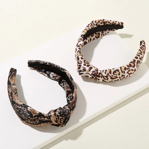 Vintage leopard and snake print headband set with stylish knot detail on a pedestal