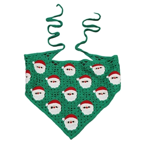 Handmade crochet Christmas bandana with Santa Claus pattern on festive green knit fabric