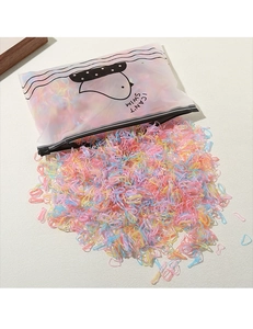 Macro detail of colorful elastic hair bands with a frosted cartoon zipper storage pouch
