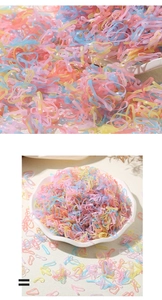 Macro shot of colorful macaron-toned elastic hair bands displayed in a ceramic dish