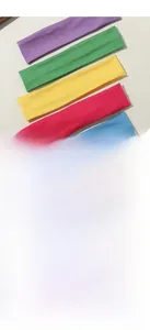 Detail of five elastic candy-colored sports headbands in purple green yellow rose and blue