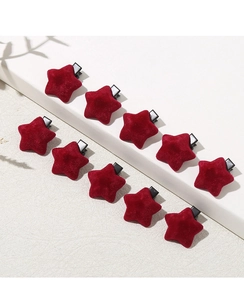 Set of ten red velvet star hair clips with metal duckbill base on cream display