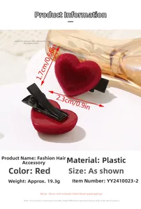 Detail shot of a pair of red flocked heart hair clips with dimensions 2.3cm by 1.7cm