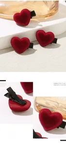 Close-up of red flocked heart hair clip with black metal duckbill clip on white background