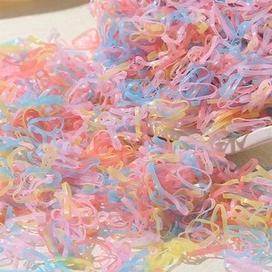 Colorful candy-colored elastic hair ties in pastel shades of pink, blue, and yellow for women