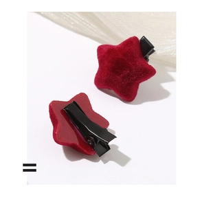 Close-up of velvet star hair clip showing soft texture and metal duckbill clip