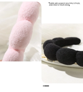 Detail of pink and black puffy spa headbands showing thick soft microfiber fabric texture