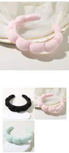 Close-up of fluffy bubble headbands in pink, black and green soft velvet material