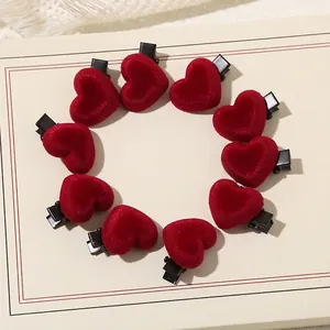 Set of 10 red velvet heart-shaped hair clips arranged in a circle on a neutral background