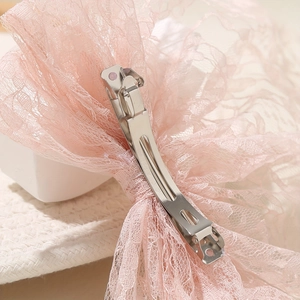 Elegant pink lace bow hair clip with intricate floral patterns and silver duckbill clip