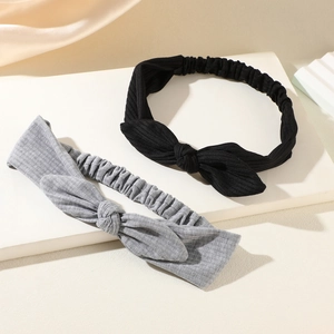 Elastic bow headbands in black and grey, featuring a soft ripple texture and stretch design