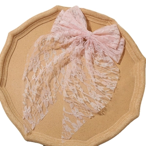 Elegant large pink lace bow hair clip featuring intricate floral patterns and a sweet design