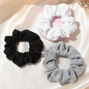 3-pack knitted scrunchies in black white and grey with fine ribbed texture for women