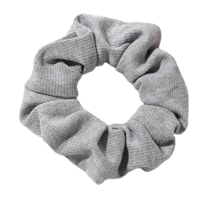 Large grey knitted scrunchie hair tie with soft pleated texture on white background