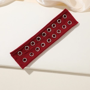 Detail of burgundy knit headband featuring dual rows of silver metal rivet eyelets