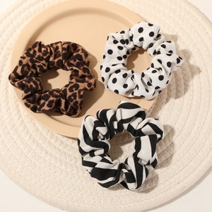 Three-piece set of zebra stripe, polka dot and leopard print scrunchies for hair styling