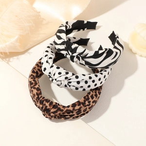 Three-piece headband set featuring zebra, polka dot, and leopard patterns with top knot