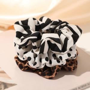 Three-piece hair scrunchie set with zebra, polka dot, and leopard patterns on satin
