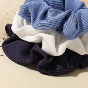 Three-pack ribbed knit scrunchies in light blue, white and navy blue colors