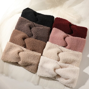 Collection of plush twist headbands in seven autumn colors on a white textured background