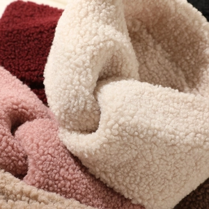 Close-up of soft plush teddy fabric texture in cream pink and brown warm headbands