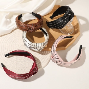 Detail of five knot headbands with satin finish and square silver stud embellishments