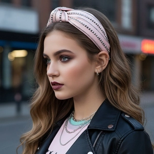 Pink satin headband with rhinestone rows and top knot on fashion model in city