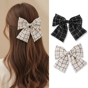 Retro plaid bow hair claw clips in black and beige displayed on model and white background