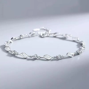 Elegant wavy silver bracelet for women featuring five round sparkling blue crystals